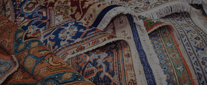 Photo of richly colored oriental rugs layered on top of each other
